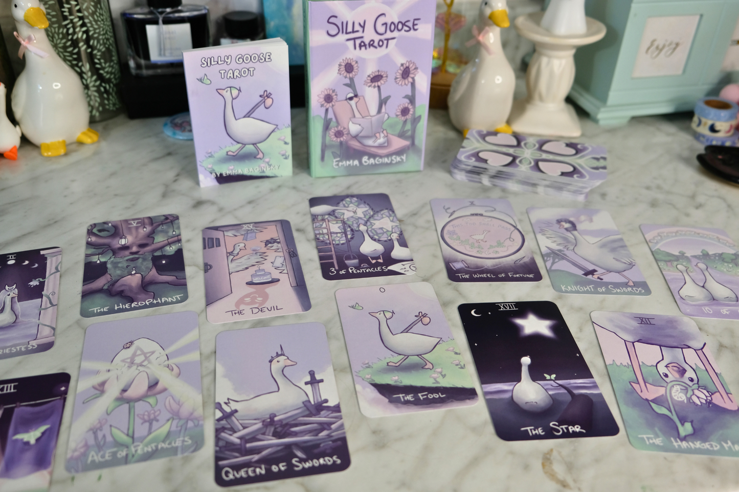 Silly Goose Tarot cards on a table with decorative items.